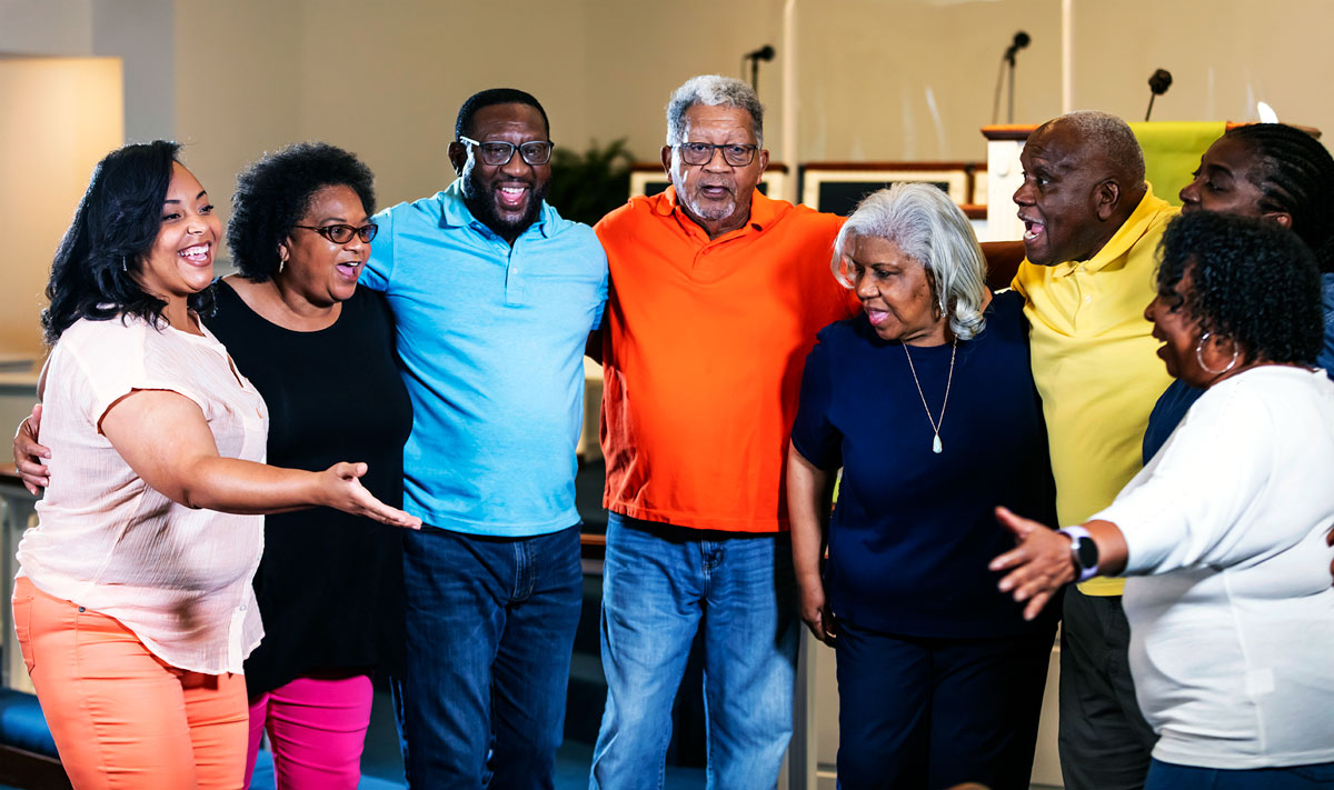 A multigenerational church community group smiling and gathered together